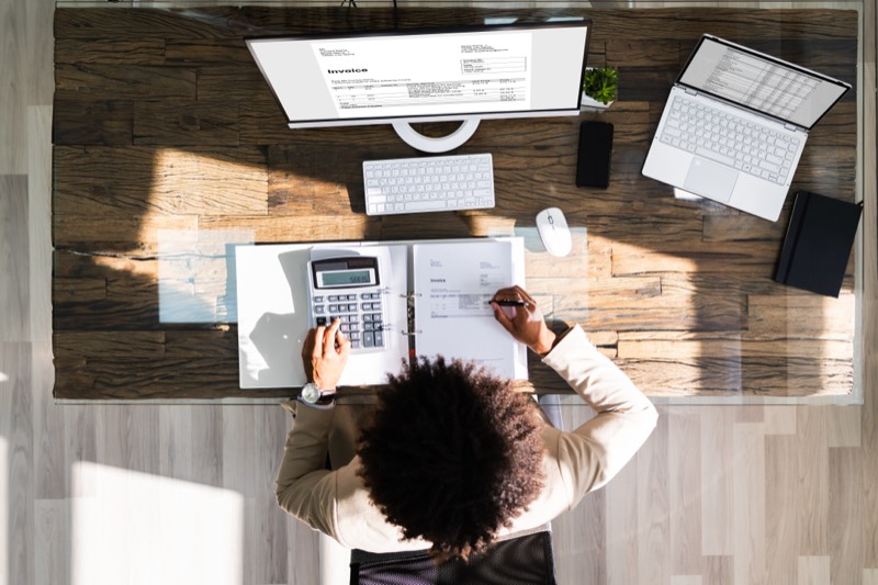Financial documents and calculator on a desk, representing factoring services